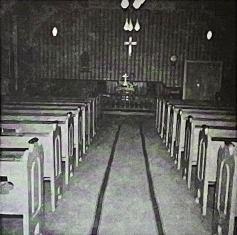 Methodist church sanctuary interior with cross, altar, and wooden pews for Sunday worship services